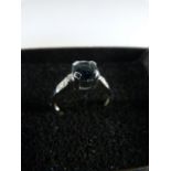 9ct Solitaire style white gold ring set with round possibly Tourmaline with two accent diamonds to