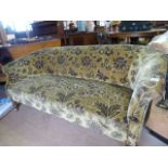Low two seater floral upholstered sofa on metal castors