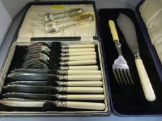 Two boxed sets of cutlery and two pairs of sugar tongs