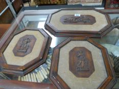 Three carved wall plaques -