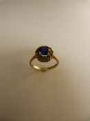 9ct gold ring set with blue sapphire stone and white stones surrounding