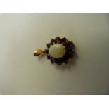 9ct Gold Amethyst and Opal pendant. The Centre opal approx 10mm x 8mm and is surrounded by 12 approx