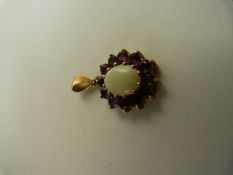 9ct Gold Amethyst and Opal pendant. The Centre opal approx 10mm x 8mm and is surrounded by 12 approx