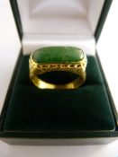 24ct (999.9) chinese saddle ring set with imperial jade. Approx 16.7mm x 7.5mm across Size Q total