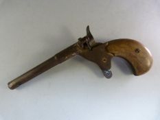 A 19th century ladies ' Bicycle ' muff pistol. Wooden grips, with single shot action. Letter B