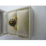 18ct Yellow Gold, yellow sapphire and Diamond cluster ring. The Yellow oval centre stone in approx