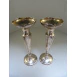 A pair of hallmarked silver candle sticks Birmingham 1914 by Henry Williamson Ltd.