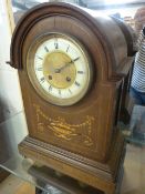 Mahogany mantle clock inlaid with floral decoration. Roman numeral chapters on an enamelled and gilt