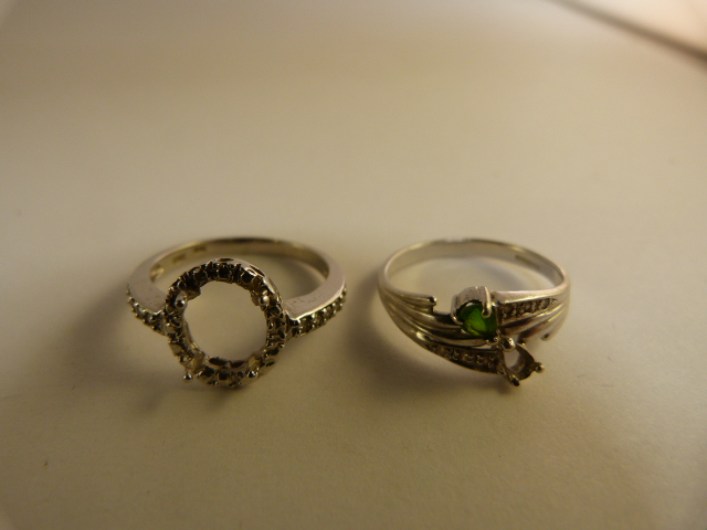 Two 9ct white gold diamond set rings in need of stones. Small crossover style Size N set with 6