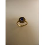 9ct gold ring set with blue sapphire stone and white stones surrounding