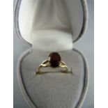 9ct Yellow Gold Solitaire garnet ring, oval garnet approx 8.1mm x 6mm across. Size UK - K US - 5.