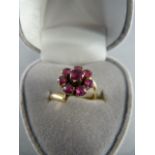 Crossover Yellow Gold (mark indistinct) Ruby Cluster ring - central stone approx 3.8mm in diameter