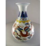 A Chinese vase depicting two dragons in clouds. Above is a collar of Imperial Yellow and