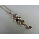 Silver articulated pendant set with various gemstones
