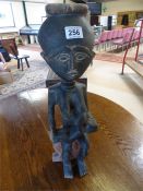 An African carved wooden figure of a mother and her baby - height 53cm