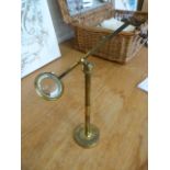 Brass scientific magnifying glass on adjustable stand