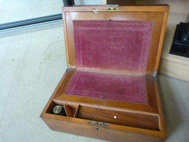 A Victorian writing slope with red fabric and original ink well