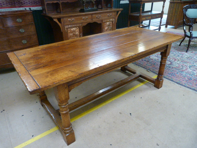 Golden oak french refectory farmhouse style table. The top formed of three panels sitting on heavy