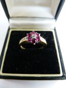 9ct Yellow Gold Ruby and Diamond cluster ring. Centre diamond approx 0.05ct surrounded by 6