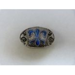 Oval enamel Murle Bennett brooch (early mark about 1910) with enamel 'Fleur-de-Lyre' in blue enamel.