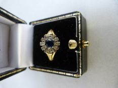 18ct Gold ring set with single sapphire stone and surrounded by diamonds