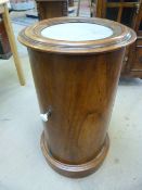 Fine example of a Victorian Mahogany pot cupboard of cylindrical form with marble inset, opening