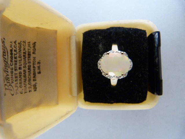 9ct Yellow Gold milky opal and diamond ring. The oval opal measures approx 10mm x 8mm with subtle - Image 2 of 6