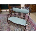 Unusual Mahogany framed two seater hall bench with green upholstered seats. With shaped top,