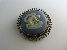 Wedgwood silver set brooch depicting cupid sharpening his arrows on a stone. 40mm in diameter