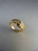 Gold ring with central diamond and diamonds to one shoulder