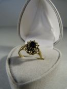 Sapphire and Diamond cluster ring set in 9ct Gold. Oval Approx 5.80mm x 4.1mm dark sapphire centre