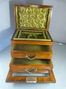 Rosewood and Glass jewellery box. Drop down front bearing bevelled glass panel leading to two