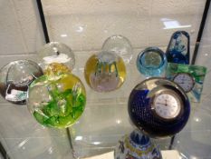 Quantity of paperweights to include Caithness clocks etc