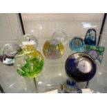 Quantity of paperweights to include Caithness clocks etc