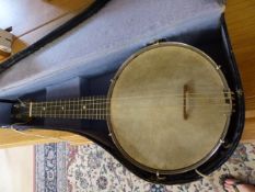 A Banjolele in case with small silver plaque engraved L.I.B and dated 1928