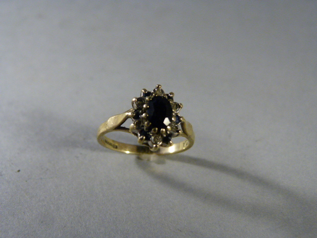 Sapphire and Diamond cluster ring set in 9ct Gold. Oval Approx 5.80mm x 4.1mm dark sapphire centre - Image 4 of 5