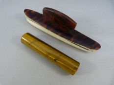 Tortoise shell nail buffer and a circular stem of Tiger's Eye