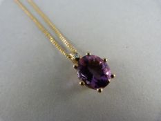 9ct Gold Amethyst and Diamond pendant on a 20" chain. The Oval amethyst is approx 12mm x 10mm with a
