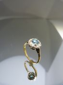 18ct Gold ring with Blue Zircon gemstone surrounded by Diamonds