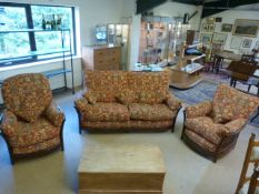 Ercol Three piece suite in darkwood with red floral upholstered cushions