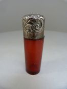 Cranberry glass perfume bottle with original stopper with Birmingham hallmarked silver lid. Repousse