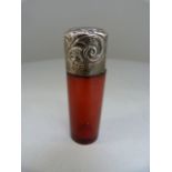 Cranberry glass perfume bottle with original stopper with Birmingham hallmarked silver lid. Repousse