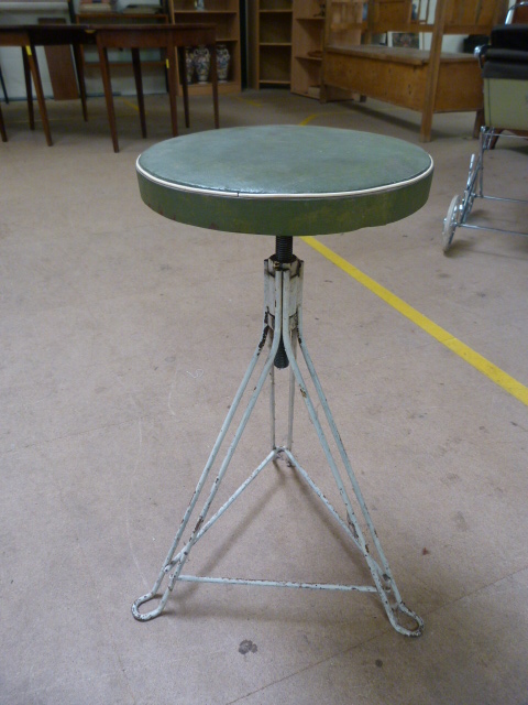 Factory metal mid century stool on tripod base and with a green leather seat