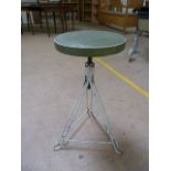 Factory metal mid century stool on tripod base and with a green leather seat