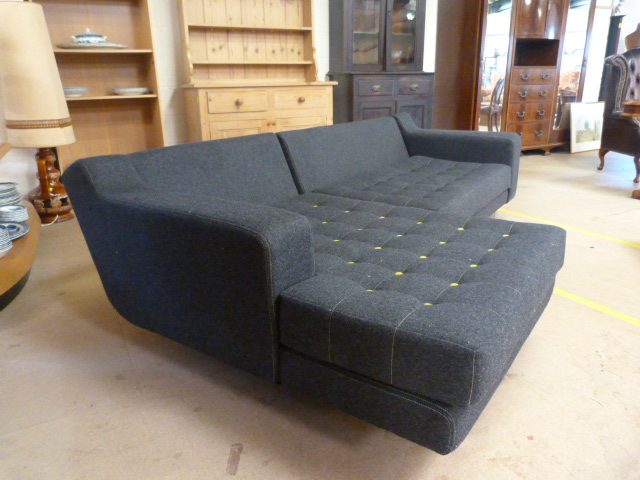 Modern modular L-shaped sofa by 'Naughtone' in grey felt with yellow buttons and chrome legs