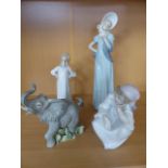 Lladro figure of a girl sitting in original Box along with another. a Nao figure and a figure of