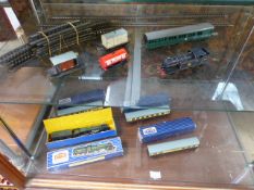 Box containing various Hornby trains and track etc over two shelves