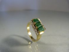 14K Emerald and Diamond contemporary ring. Three approx 4.55mm x 3.16mm emeralds side by side across