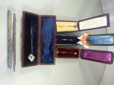 Collection of four Antique pins some containing Gem stones in original boxes. An enamelled butterfly