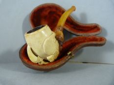 Carved meerschaum and Amber smokers pipe in an Eagle Claw design. In original fitted case